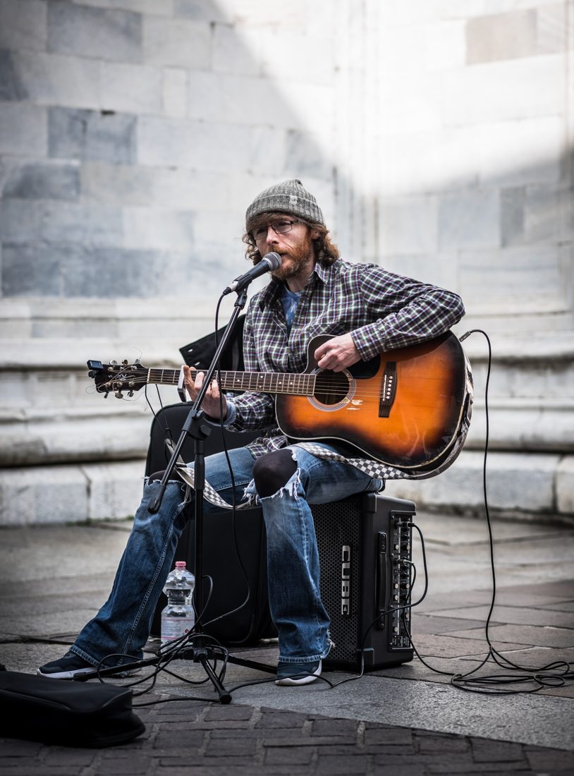 Busker with acoustic guitar